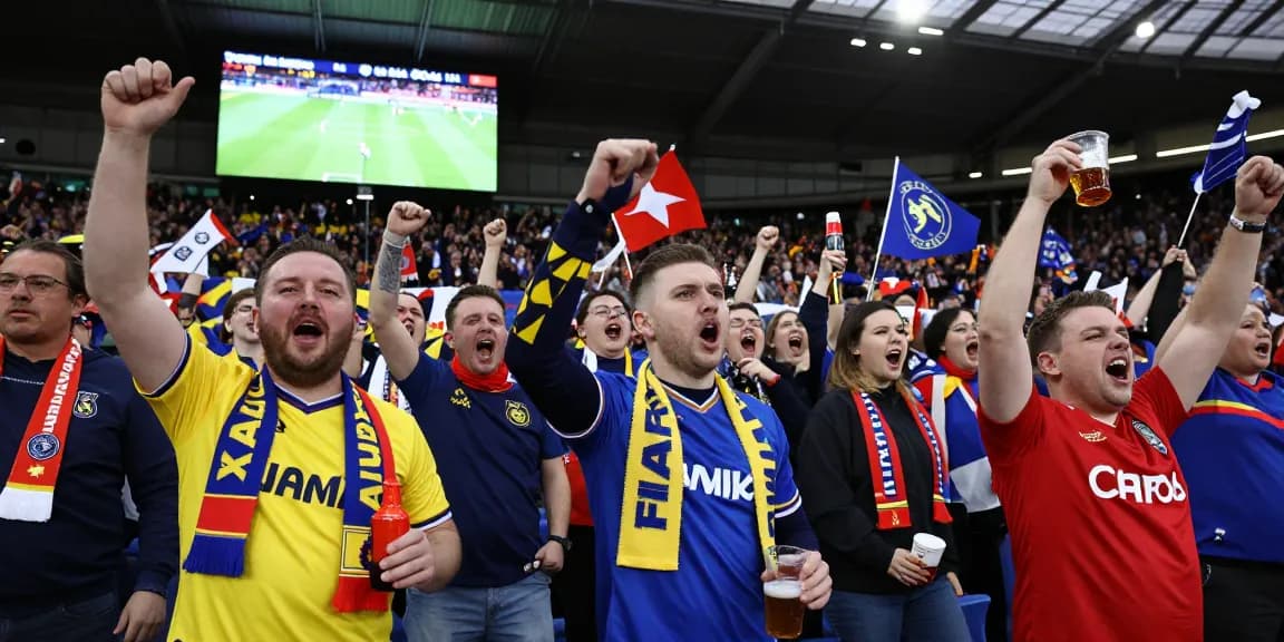 Excited football fans at a Premier League match, bk8 community celebrating their teams.